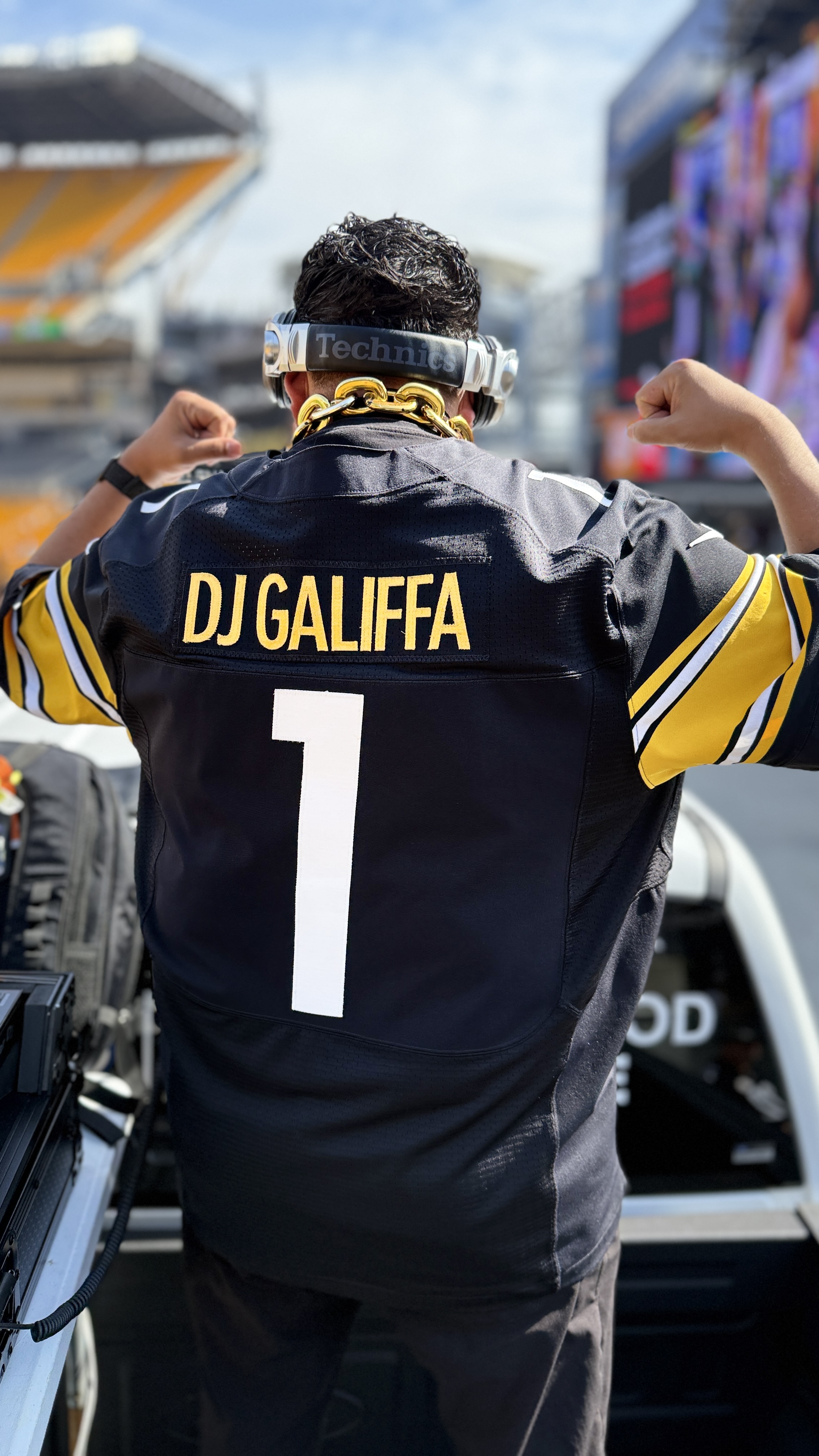 DJ Galiffa raising both arms in his number one Steelers jersey at Acrisure Stadium